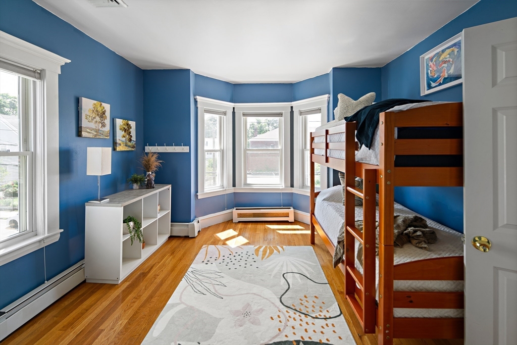 32 Harvard Street, Unit 2 Waltham, MA 02453 - Photo 20 of 32 a view of a bedroom with furniture and a window