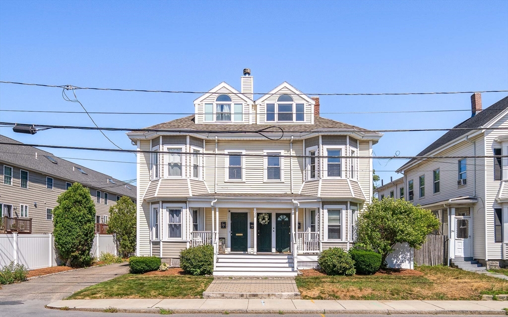 32 Harvard Street, Unit 2 Waltham, MA 02453 - Photo 2 of 32 a view of white house with windows and plants