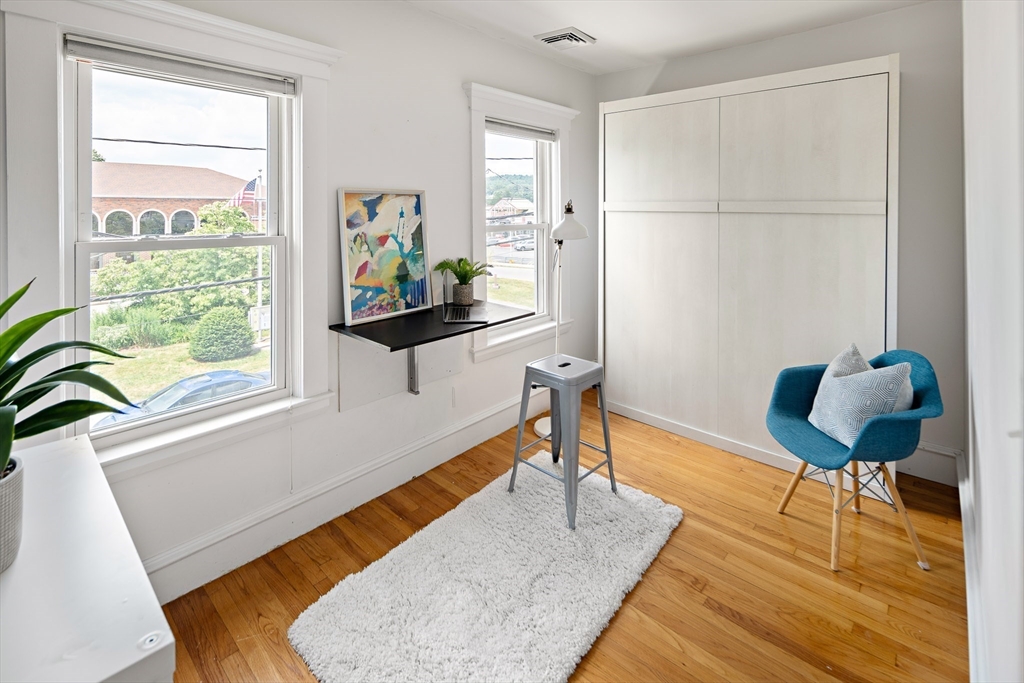 32 Harvard Street, Unit 2 Waltham, MA 02453 - Photo 22 of 32 a living room with furniture and a wooden floor