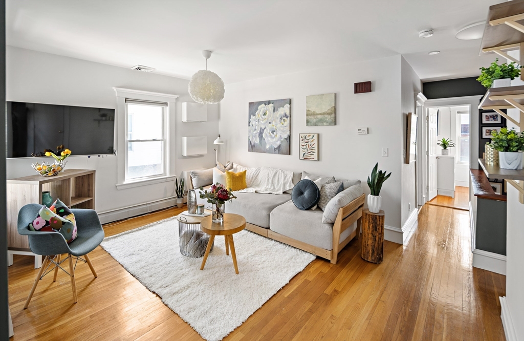 32 Harvard Street, Unit 2 Waltham, MA 02453 - Photo 3 of 32 a living room with furniture and a wooden floor
