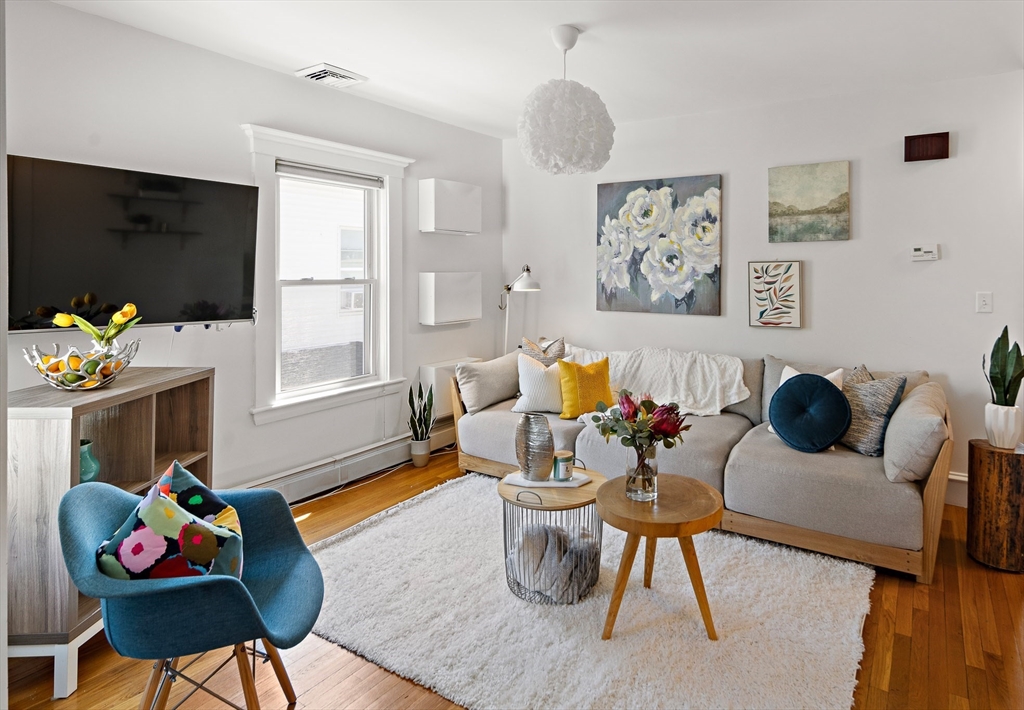 32 Harvard Street, Unit 2 Waltham, MA 02453 - Photo 4 of 32 a living room with furniture and a flat screen tv