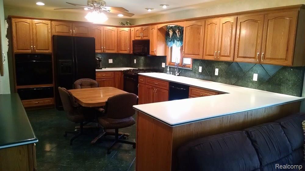 9674 Reeck Road Allen Park, MI 48101 - Photo 12 of 28 ENOUGH CABINETS AND COUNTERSPACE FOR YOU? VIEW IS FROM THE FAMILY ROOM. NOTE THE SECRETARY STATION ON THE FAR LEFT. ALSO, RANGE, SECOND OVEN AND WARMING DRAWER INCLUDED!