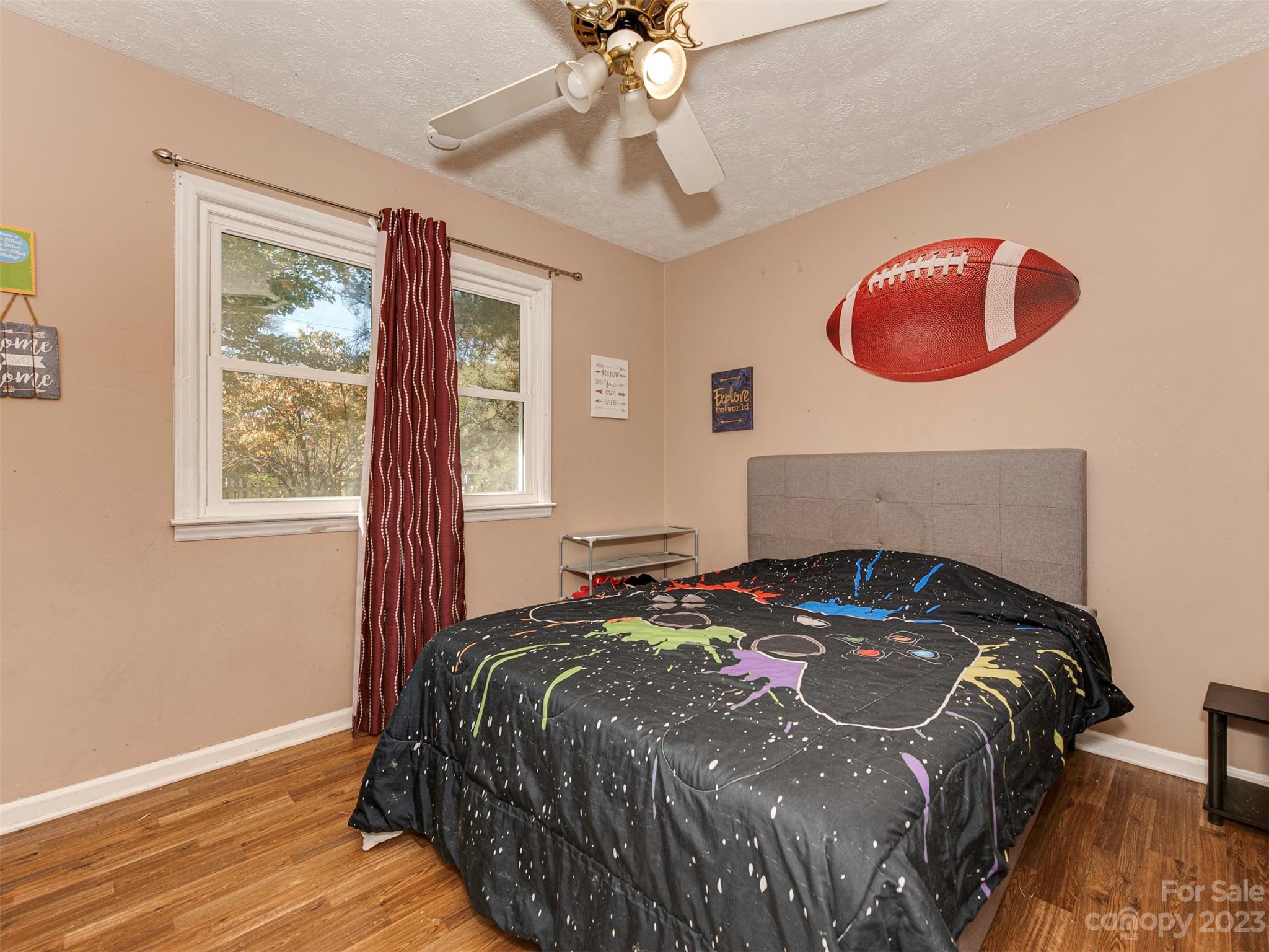 125 Eason Drive Rockingham, NC 28379 - Photo 20 of 26 a bedroom with a bed and a chandelier