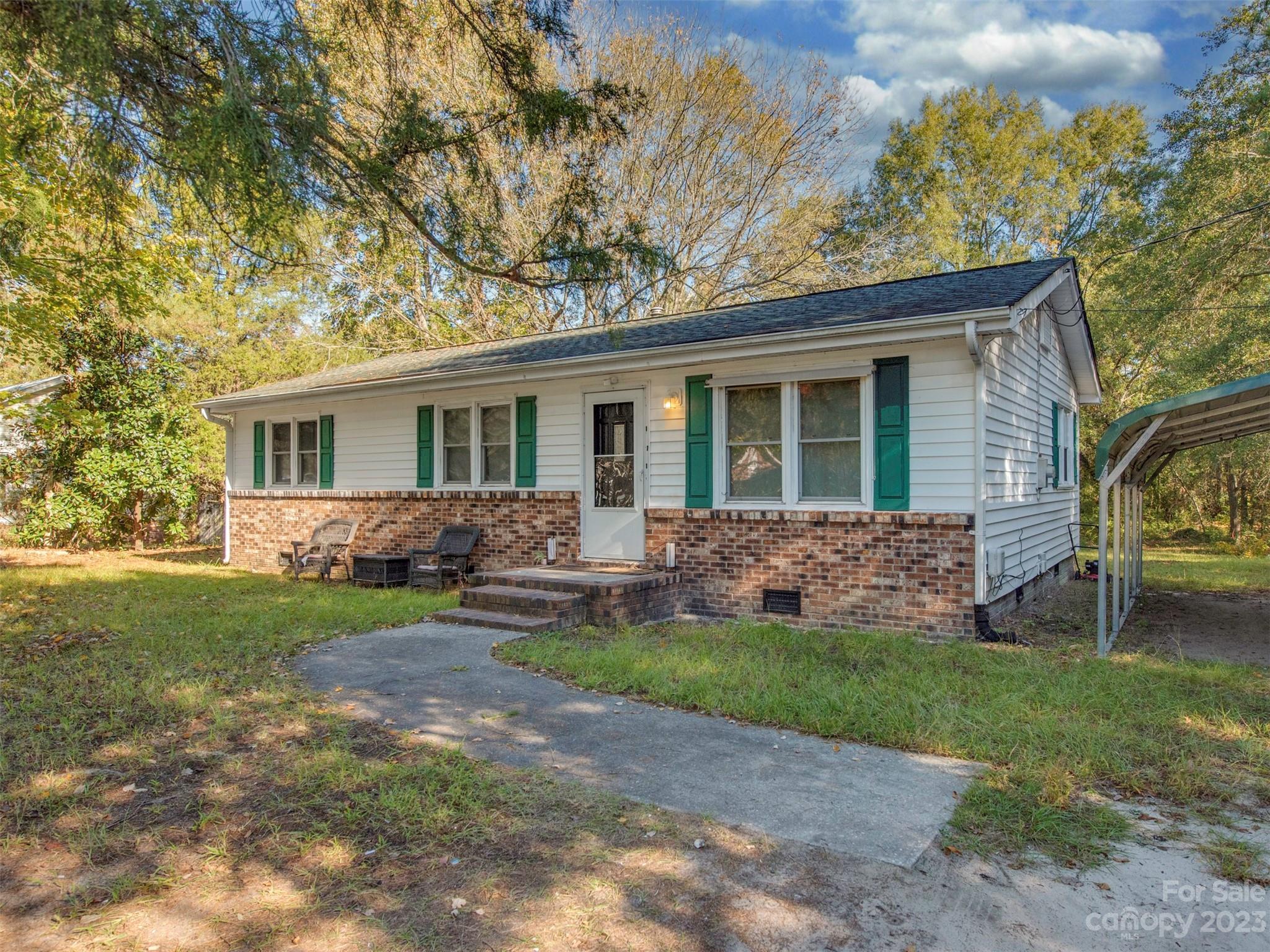 125 Eason Drive Rockingham, NC 28379 - Photo 3 of 26 front view of a house that has a yard