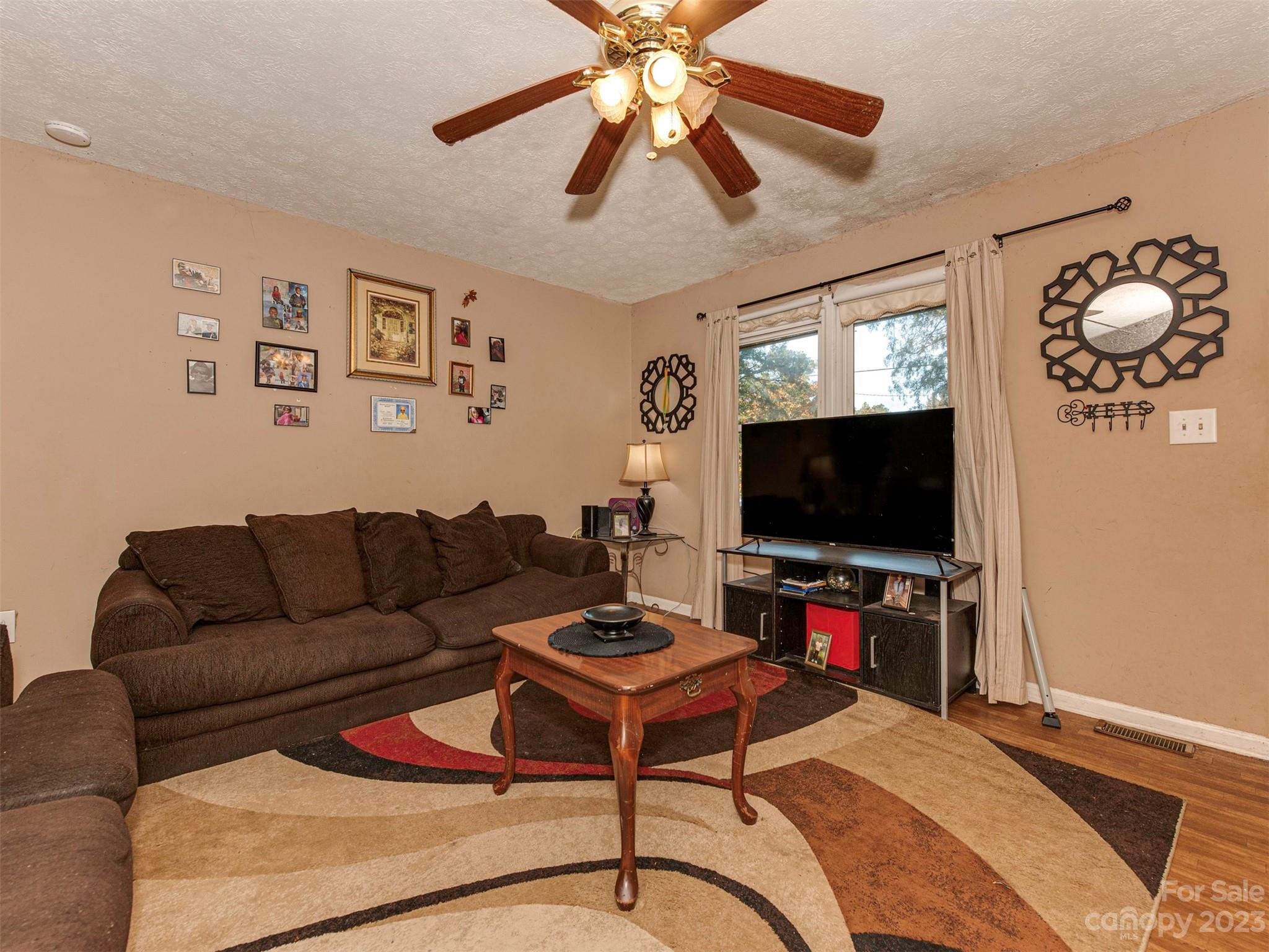 125 Eason Drive Rockingham, NC 28379 - Photo 7 of 26 a living room with furniture and a flat screen tv