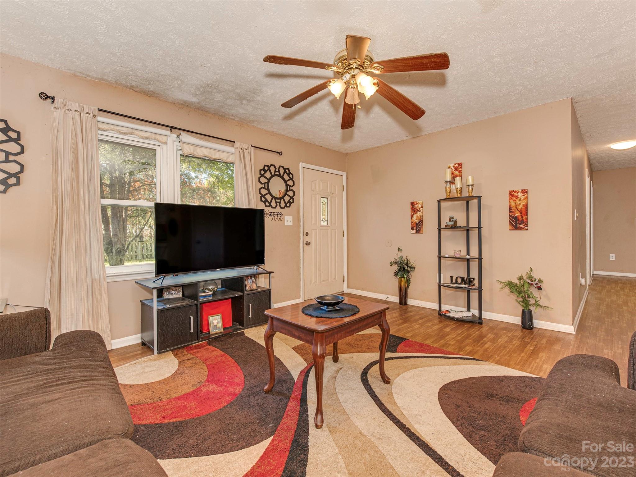 125 Eason Drive Rockingham, NC 28379 - Photo 8 of 26 a living room with furniture and a flat screen tv