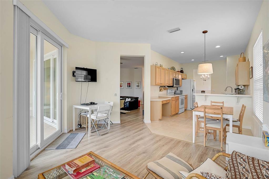 7012 Prosperity Circle, Unit 706 Sarasota, FL 34238 - Photo 11 of 45 a kitchen with stainless steel appliances granite countertop a stove a sink dishwasher and a dining table with kitchen view