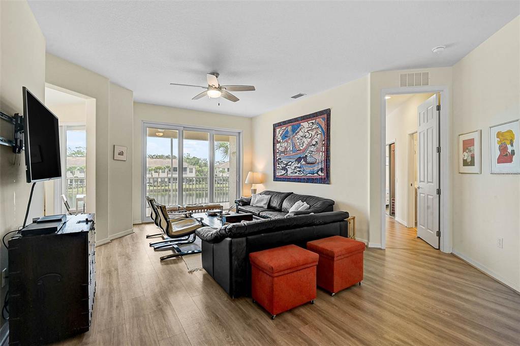7012 Prosperity Circle, Unit 706 Sarasota, FL 34238 - Photo 3 of 45 a living room with furniture and a flat screen tv