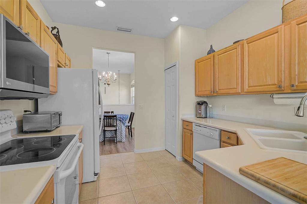 7012 Prosperity Circle, Unit 706 Sarasota, FL 34238 - Photo 9 of 45 a kitchen that has a sink and a stove in it