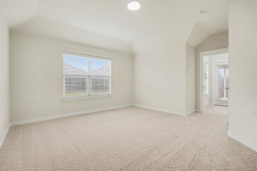 2606 Middleton Road Glenn Heights, TX 75154 - Photo 17 of 18 Carpeted room featuring a window with blinds, vaulted ceiling, and recessed lighting