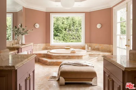 a bathroom with a shower and a glass door