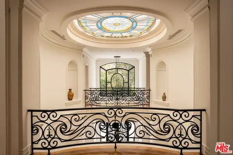 a bedroom with two beds and a large window with outer view