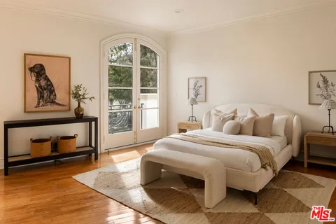 a bedroom with a bed and a tv