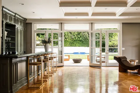 a kitchen with a stove cabinets and chairs