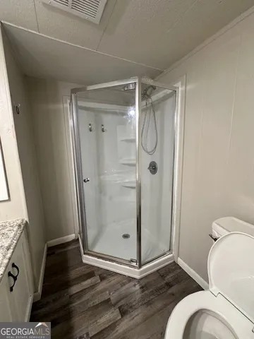 a bathroom with a glass shower door