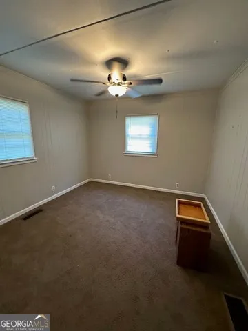 a view of room with a ceiling fan and window