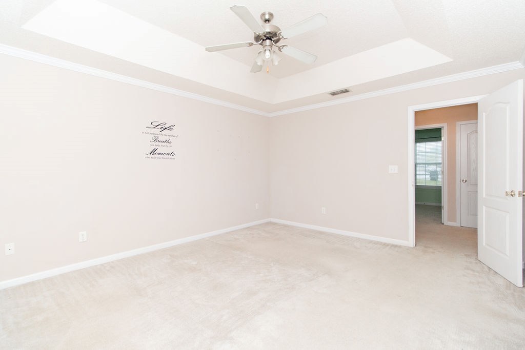 352 Autumn Ridge Trail Gray, GA 31032 - Photo 18 of 36 an empty room with a ceiling fan and a window