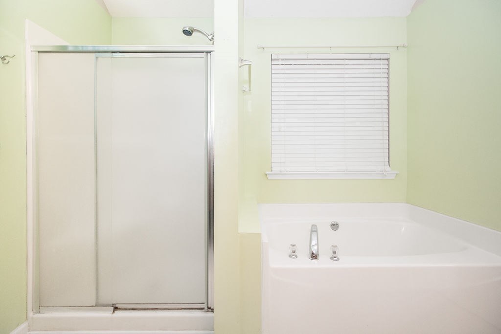 352 Autumn Ridge Trail Gray, GA 31032 - Photo 22 of 36 a bathroom with a bathtub and a shower