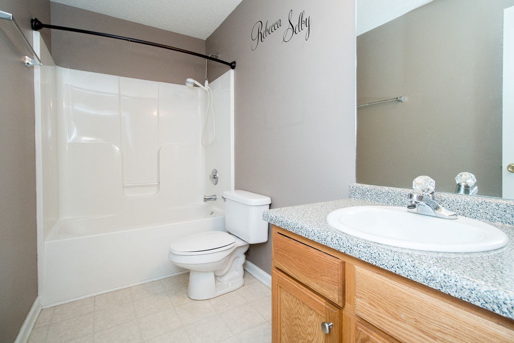 352 Autumn Ridge Trail Gray, GA 31032 - Photo 26 of 36 a bathroom with a granite countertop sink a toilet and a mirror