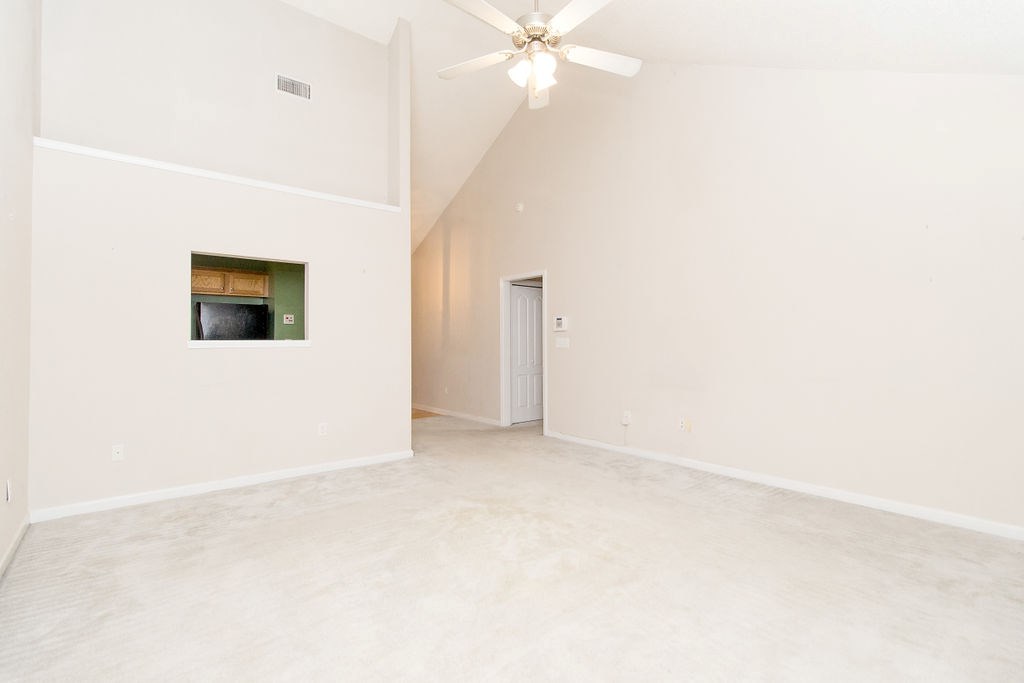 352 Autumn Ridge Trail Gray, GA 31032 - Photo 5 of 36 an empty room with a ceiling fan and a window