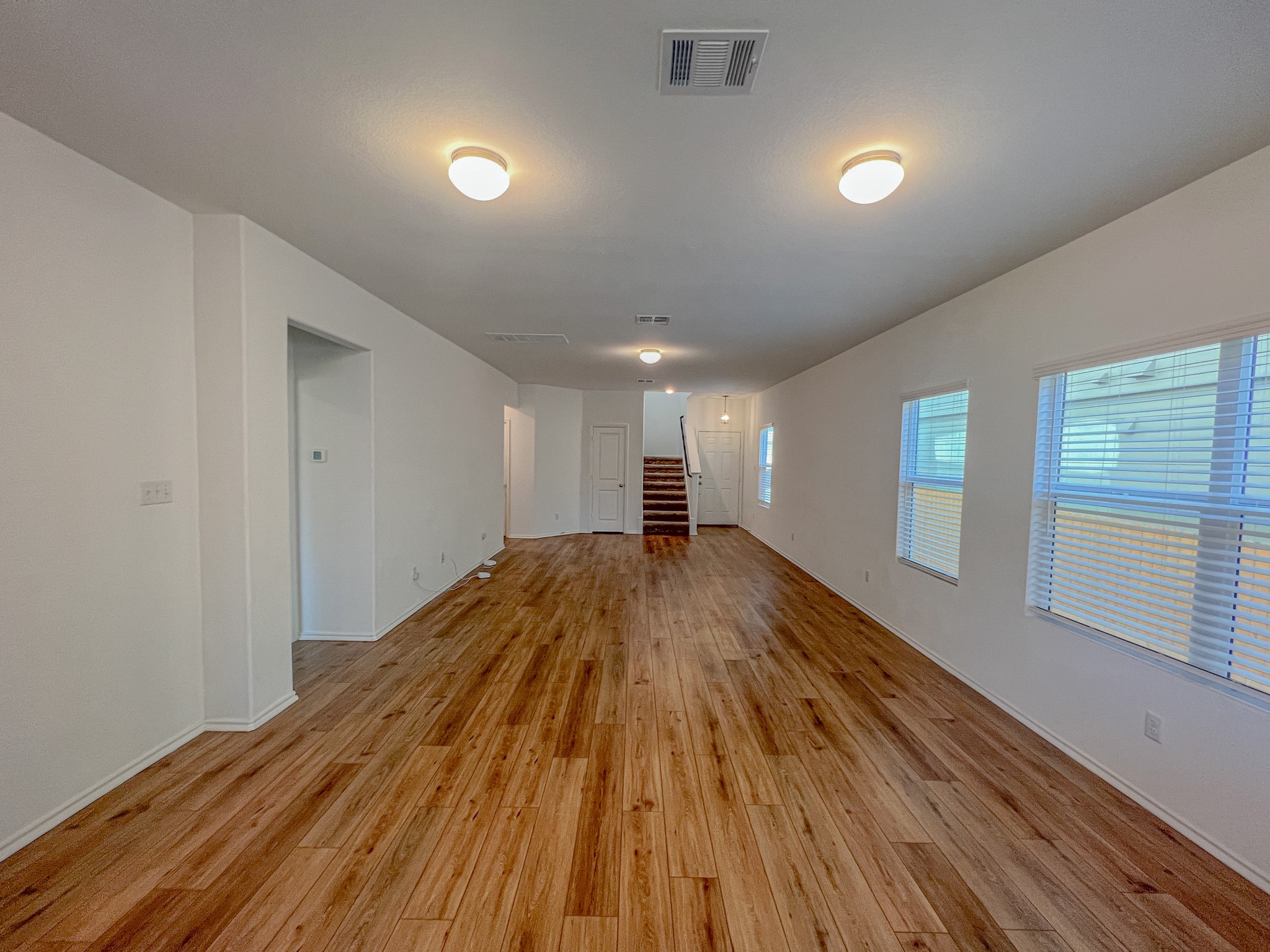 438 Perfect World Loop Jarrell, TX 76537 - Photo 7 of 35 a view of empty room with wooden floor