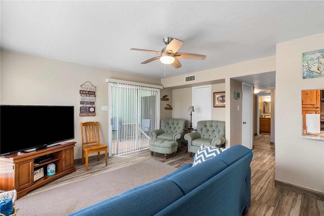 14300 Aloha Street, Unit 139 Corpus Christi, TX 78418 - Photo 17 of 26 a living room with furniture and a flat screen tv