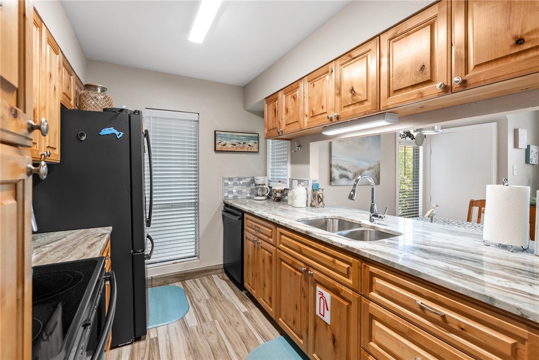 14300 Aloha Street, Unit 139 Corpus Christi, TX 78418 - Photo 24 of 26 a kitchen with stainless steel appliances granite countertop a sink and cabinets