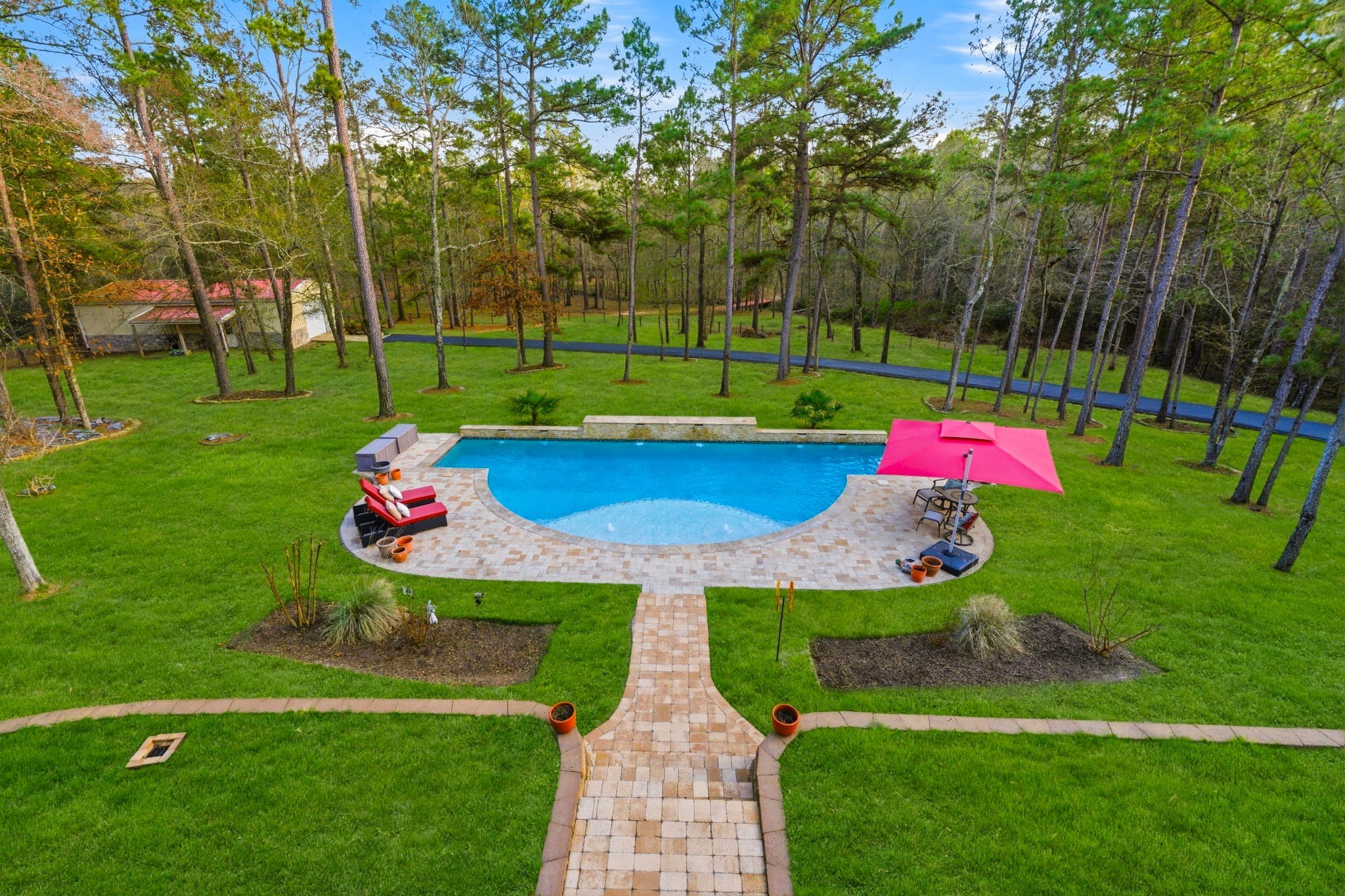 280 Sundog Road Huntsville, TX 77340 - Photo 44 of 50 Elevated view from the upstairs balcony showcasing the pool and spacious backyard setting.