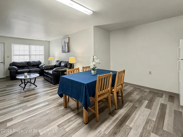 a living room with furniture a rug and a window