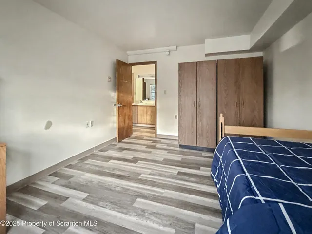 a bedroom with a bed and cabinets