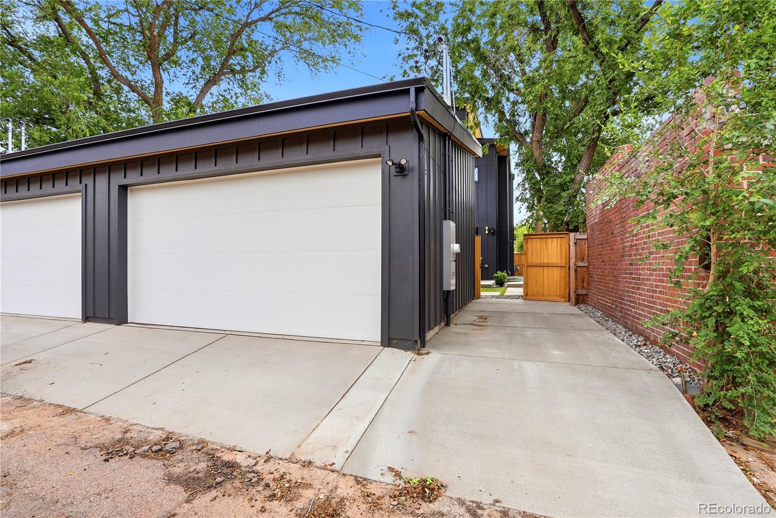 245 South Emerson Street Denver, CO 80209 - Photo 46 of 49 a backyard of a house with wooden fence and trees