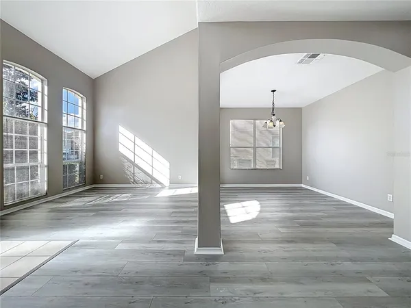a kitchen with granite countertop stainless steel appliances white cabinets granite counter tops and a wooden floor