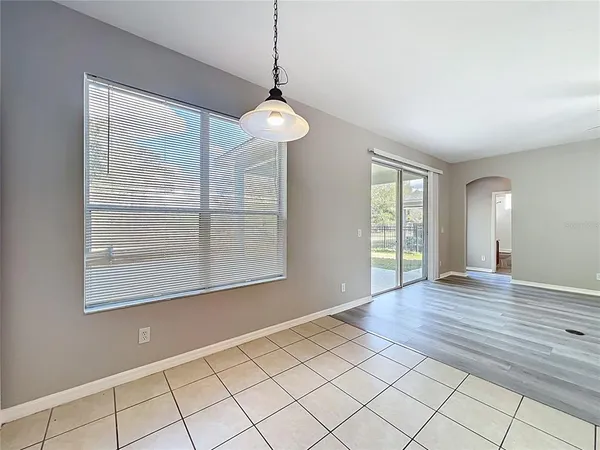 a large kitchen with a large counter top stainless steel appliances and cabinets