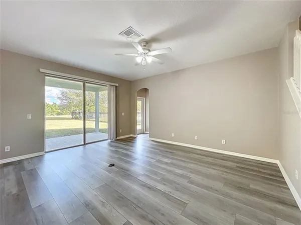 a bathroom with a granite countertop toilet a sink and a large mirror