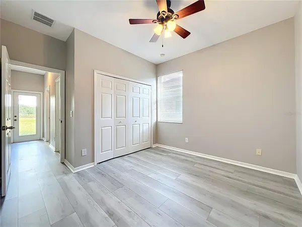 a view of staircase with railing and white walls