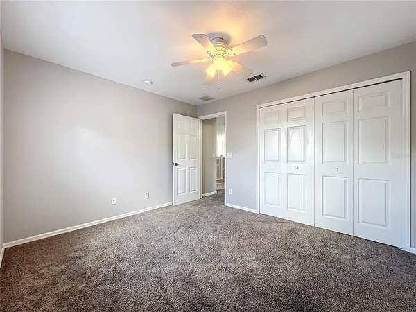 a bathroom with a granite countertop bathtub a sink and a mirror