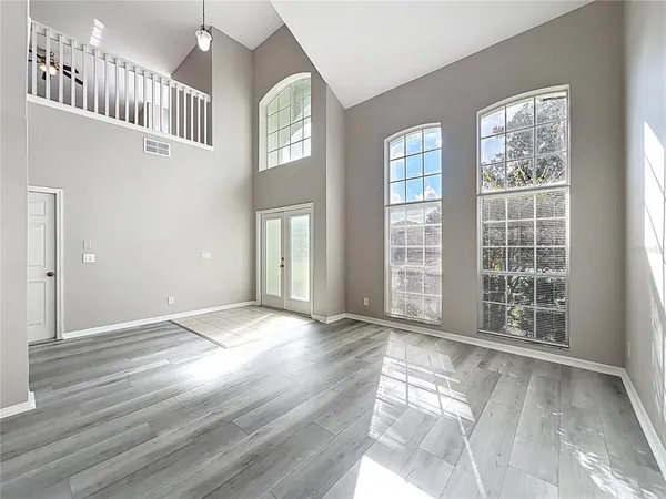 a view of a room with wooden floor and windows