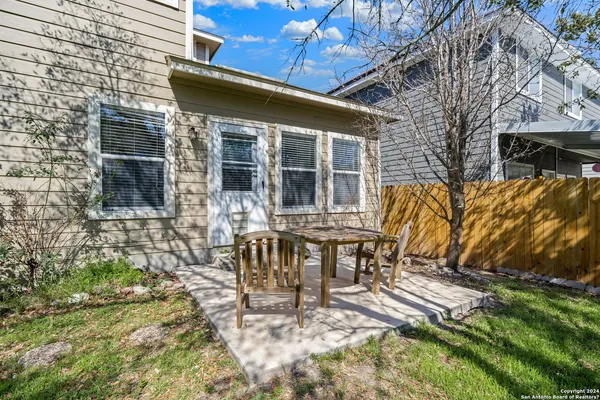 a view of a house with backyard and sitting area