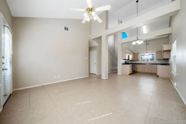 a view of a kitchen with a sink and a refrigerator