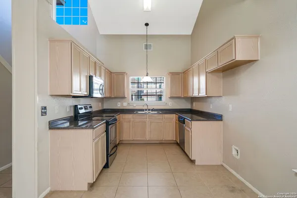 a kitchen with stainless steel appliances granite countertop a sink and cabinets