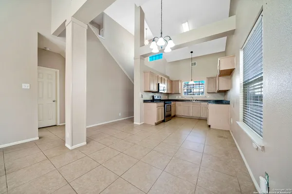 a large white kitchen with cabinets