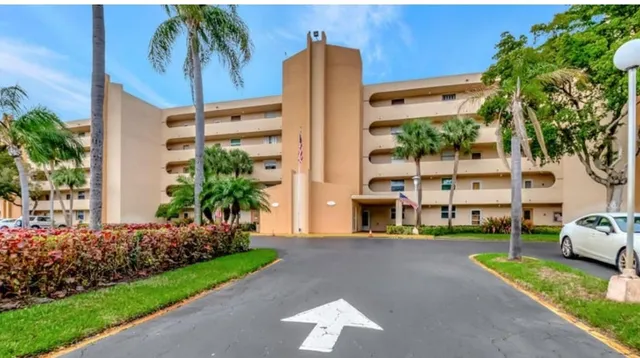a front view of multiple houses with yard