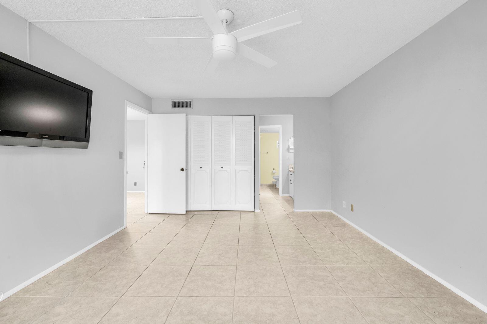 6461 Northwest 2nd Avenue, Unit 403 Boca Raton, FL 33487 - Photo 19 of 22 a view of an empty room with a flat screen tv