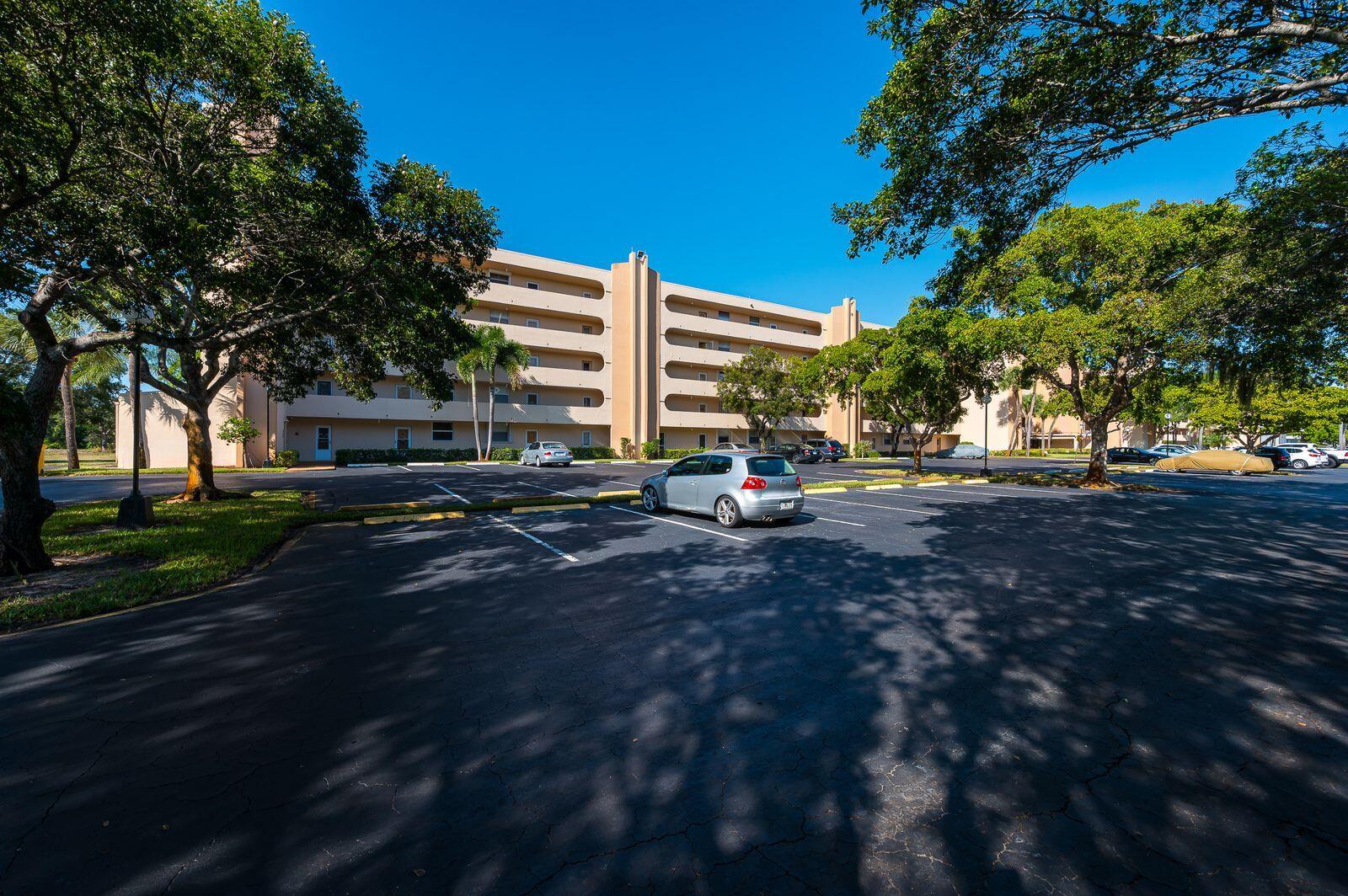 6461 Northwest 2nd Avenue, Unit 403 Boca Raton, FL 33487 - Photo 2 of 22 a view of road with trees