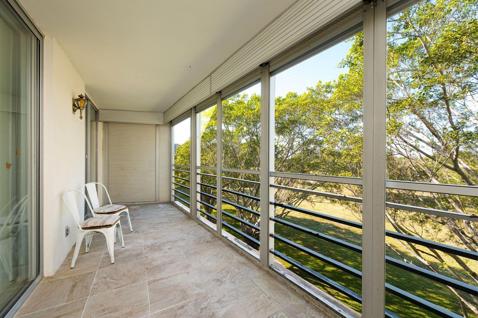 6461 Northwest 2nd Avenue, Unit 403 Boca Raton, FL 33487 - Photo 21 of 22 a view of an empty room with wooden floor and chair