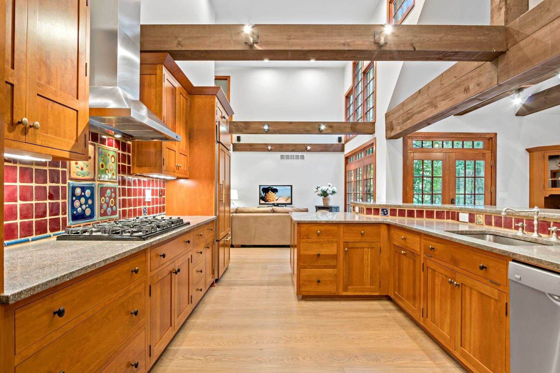 111 Old Kingdom Road Wilton, CT 06897 - Photo 16 of 57 a large kitchen with stainless steel appliances a sink and cabinets