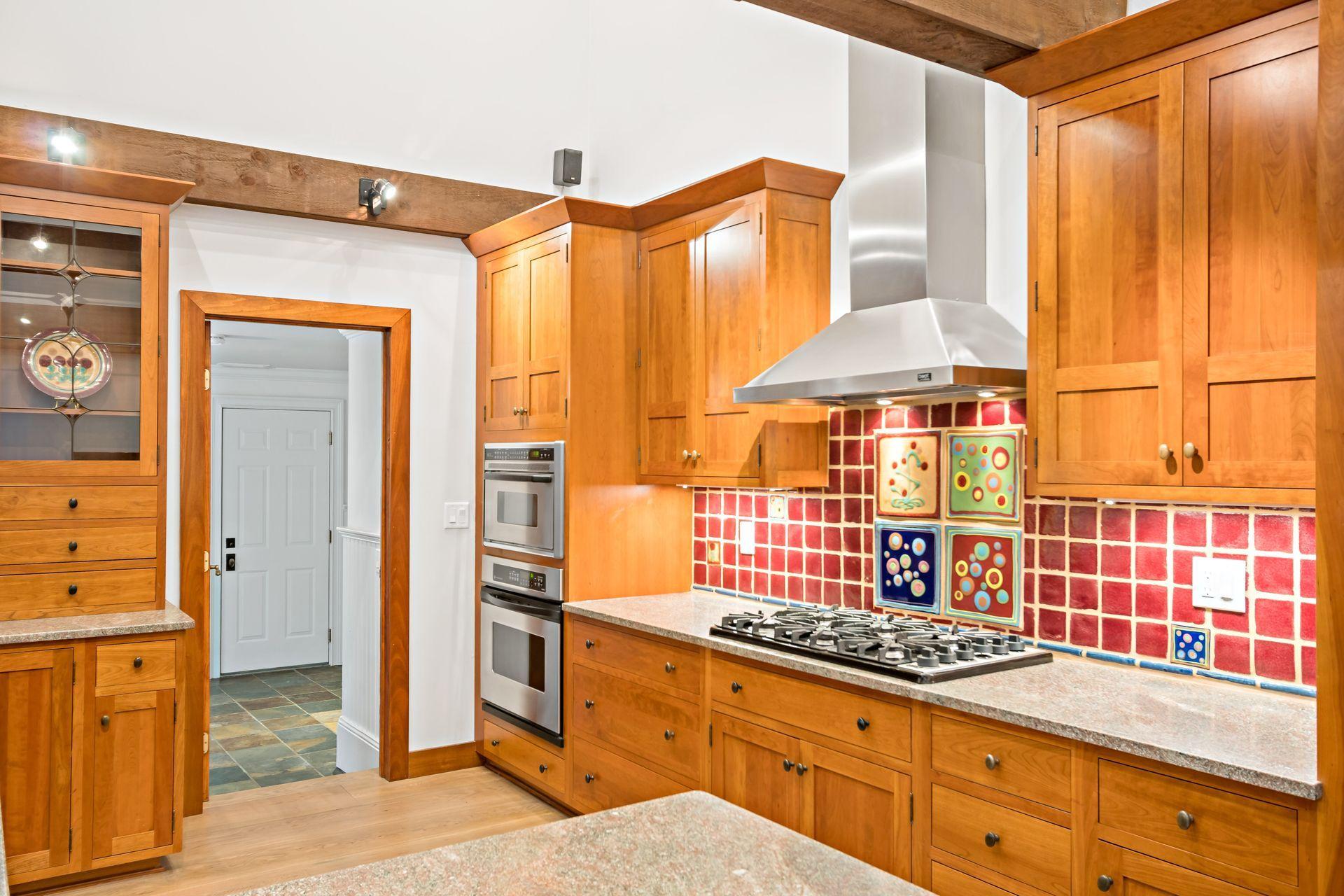 111 Old Kingdom Road Wilton, CT 06897 - Photo 23 of 57 a kitchen with stainless steel appliances granite countertop a stove and a refrigerator