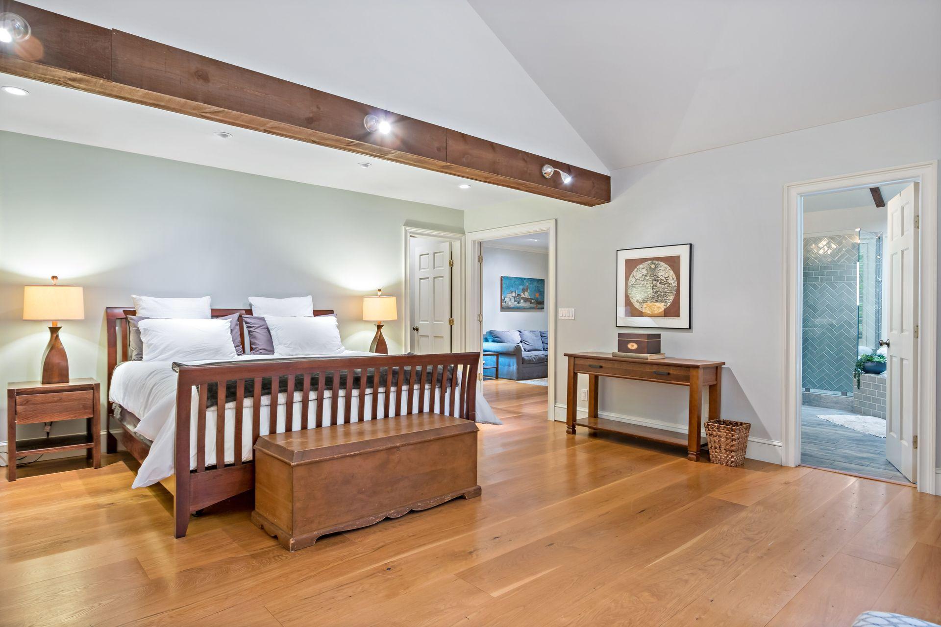 111 Old Kingdom Road Wilton, CT 06897 - Photo 29 of 57 a bedroom with a bed and a night stand with potted plant