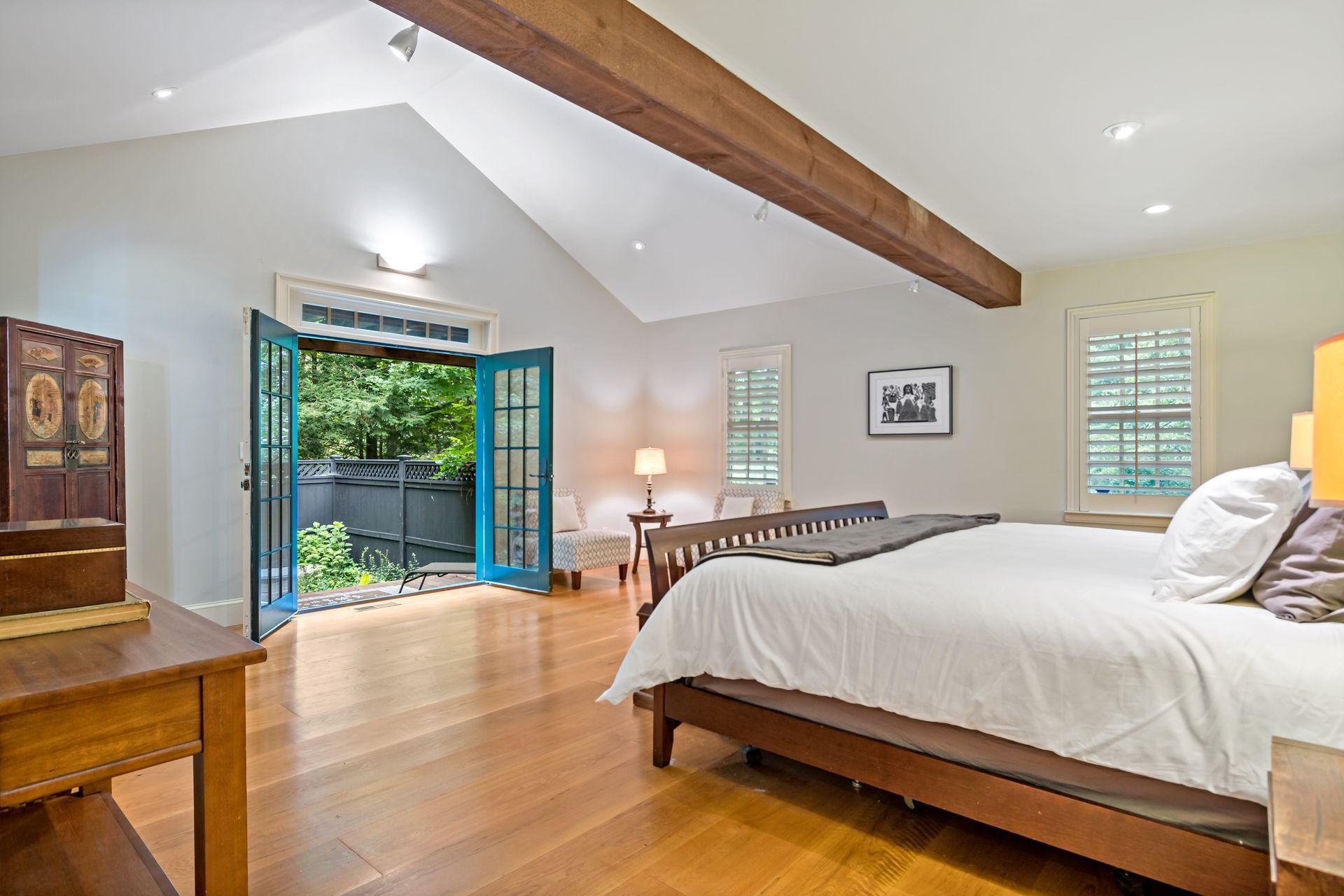 111 Old Kingdom Road Wilton, CT 06897 - Photo 31 of 57 a bedroom with a bed and a large window