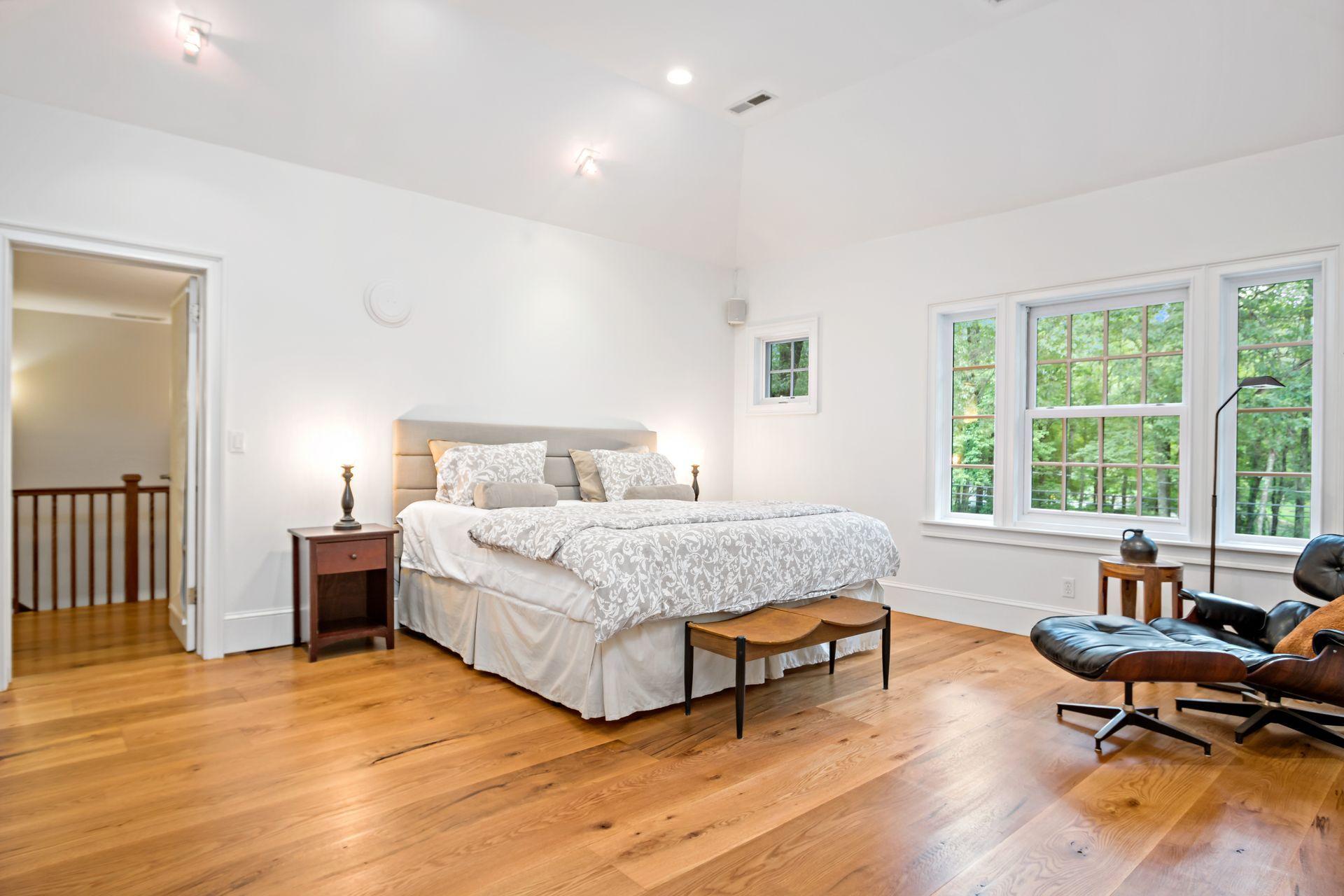 111 Old Kingdom Road Wilton, CT 06897 - Photo 41 of 57 a bedroom with a bed and wooden floor